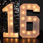 Illuminated marquee number 16 on a reflective surface.